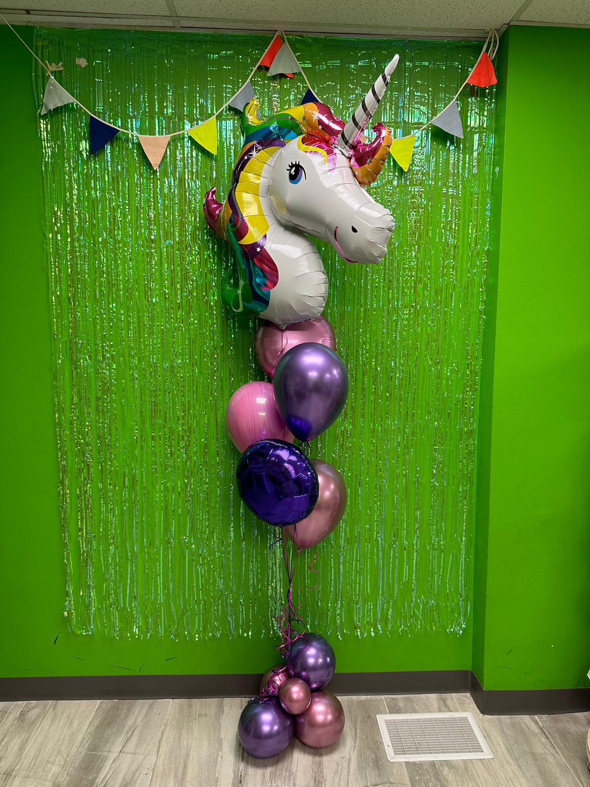 Rainbow unicorn balloon bouquet with balloon base weight